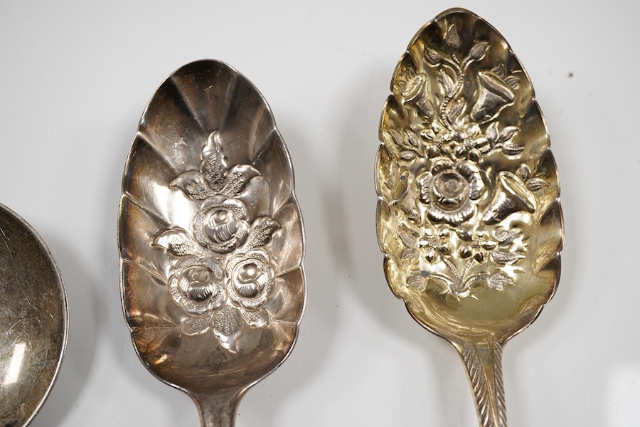 A pair of George III silver gilt Old English pattern berry spoons, London, 1787, 21.8cm, two other earlier silver berry spoons and an Edwardian serving spoon by William Hutton & Sons, London, 1901, 9oz.